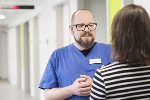 Eine Pflegekraft im Gespräch mit einer Angehörigen.
