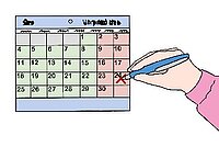 Eine Hand schreibt in einen Kalender